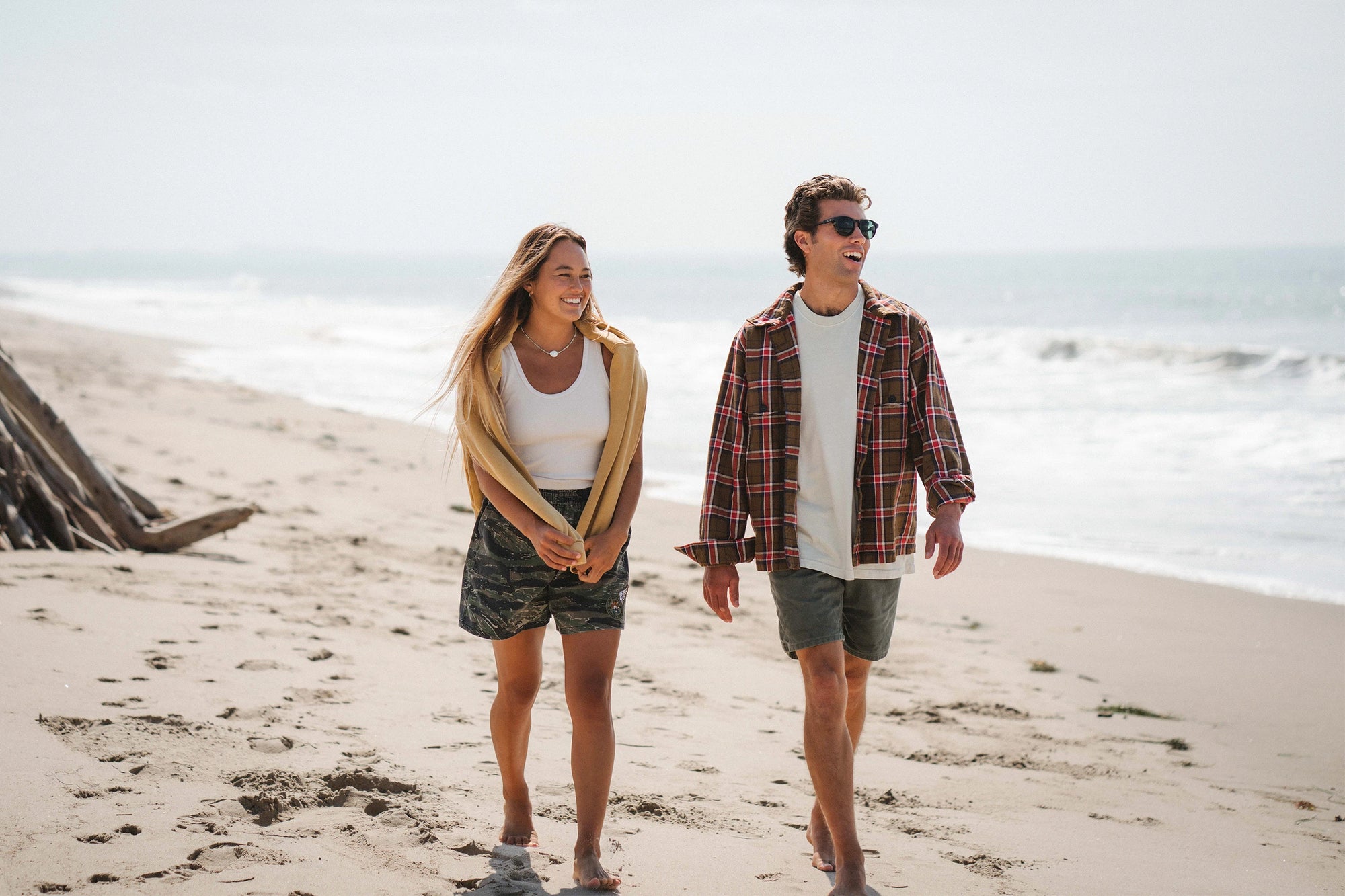 Man and Woman walking on beach wearing ARIKO LA Surf Apparel